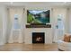 Beautiful living room with a cozy fireplace, large TV, and elegant curtains at 1724 Deacon Falls Way, Wendell, NC 27591
