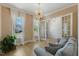 Cozy living room featuring neutral tones, large windows and an elegant chandelier at 1724 Deacon Falls Way, Wendell, NC 27591