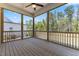 Screened porch with wood flooring, fan, and a view of the backyard at 1724 Deacon Falls Way, Wendell, NC 27591