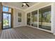 Screened porch with wood flooring, fan, and view to interior and exterior at 1724 Deacon Falls Way, Wendell, NC 27591
