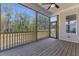 Screened porch with wood flooring, fan, and a view of the backyard at 1724 Deacon Falls Way, Wendell, NC 27591