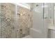 Close-up of the walk-in shower featuring detailed tile design and built-in bench seating at 1724 Deacon Falls Way, Wendell, NC 27591