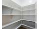 Well-organized walk-in closet features ample shelving and storage space at 1724 Deacon Falls Way, Wendell, NC 27591