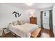 Inviting bedroom featuring a comfortable bed, wood floors, dresser, and natural light, creates a relaxing atmosphere at 2008 Stanwood Dr, Apex, NC 27502