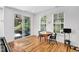 Bright dining area features hardwood floors, large windows, and a sliding glass door to the porch at 2008 Stanwood Dr, Apex, NC 27502