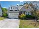 Inviting home featuring a neutral palette, well-kept lawn, dormer windows, and an attached two-car garage at 2008 Stanwood Dr, Apex, NC 27502