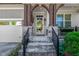 Stylish front entrance features stone accents, craftsman style beams and a glass front door at 2008 Stanwood Dr, Apex, NC 27502