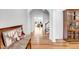 Open hallway with hardwood floors, white walls, and views into the living room at 2008 Stanwood Dr, Apex, NC 27502