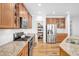 Gourmet kitchen boasts wood cabinets, granite countertops, stainless steel appliances, and a walk-in pantry at 2008 Stanwood Dr, Apex, NC 27502