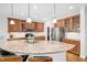 Bright kitchen features a granite island, wood cabinets, stainless steel appliances, and hardwood flooring at 2008 Stanwood Dr, Apex, NC 27502