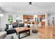 Spacious living room featuring an open layout, a kitchen island, and hardwood floors at 2008 Stanwood Dr, Apex, NC 27502