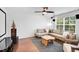 Cozy living room featuring projector and screen, comfortable sectional, and hardwood flooring at 2008 Stanwood Dr, Apex, NC 27502