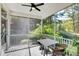 Relaxing screened porch features a ceiling fan, outdoor dining furniture, and views of the backyard at 2008 Stanwood Dr, Apex, NC 27502