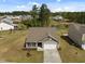 Aerial view of a home with a well-kept lawn, driveway, garage, and neighborhood surroundings at 2040 Alderman Way, Creedmoor, NC 27522