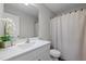 Bright bathroom featuring a white vanity with sink, a mirror, and a shower with a patterned curtain at 2040 Alderman Way, Creedmoor, NC 27522