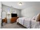 Cozy bedroom featuring a soft bed, dresser with a television, mirror, and natural light from a window at 2040 Alderman Way, Creedmoor, NC 27522