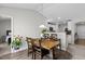 Cozy dining area with a wooden table, chairs, and view of the modern kitchen at 2040 Alderman Way, Creedmoor, NC 27522