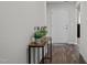Welcoming entryway featuring wood flooring, a decorative table with plants, and a front door at 2040 Alderman Way, Creedmoor, NC 27522