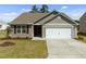 Charming single-story home featuring neutral siding, a two-car garage, and a well-manicured lawn at 2040 Alderman Way, Creedmoor, NC 27522