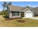 Charming home featuring a two-car garage, manicured lawn, and pleasant landscaping, showing street view at 2040 Alderman Way, Creedmoor, NC 27522