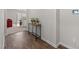 Inviting hallway with hardwood floors, table decor, and smart home panel for modern living at 2040 Alderman Way, Creedmoor, NC 27522