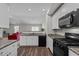 Modern kitchen with stainless steel appliances, granite countertops, and an open view to the living room at 2040 Alderman Way, Creedmoor, NC 27522