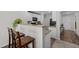 Open-concept kitchen with a granite-topped breakfast bar, offering seating and a view into other rooms at 2040 Alderman Way, Creedmoor, NC 27522