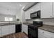 Contemporary kitchen featuring stainless steel appliances, granite countertops, and ample cabinet space at 2040 Alderman Way, Creedmoor, NC 27522