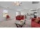 Bright open-concept living room featuring a ceiling fan and seamlessly connecting to the kitchen at 2040 Alderman Way, Creedmoor, NC 27522