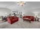 Spacious living room with plush seating, ceiling fan and connecting dining and kitchen spaces at 2040 Alderman Way, Creedmoor, NC 27522