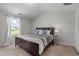 Cozy bedroom with a plush bed, soft carpeting, and a large window offering plenty of natural light at 2040 Alderman Way, Creedmoor, NC 27522