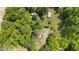 Aerial view of the property highlighting a home, storage buildings, lush trees, and greenery, offering privacy at 209 Pen Lou Ct, Angier, NC 27501