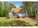Exterior view of the home showcasing the expansive backyard and inviting back deck at 209 Pen Lou Ct, Angier, NC 27501