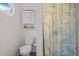 Charming bathroom with toilet, decorative accents, cabinet, and a whimsical patterned shower curtain at 209 Pen Lou Ct, Angier, NC 27501