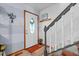 Bright entryway featuring a decorative front door, staircase, and fresh paint, creating a welcoming space at 209 Pen Lou Ct, Angier, NC 27501