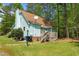 Exterior of house displaying the architectural style with a well-maintained lawn and surrounding trees at 209 Pen Lou Ct, Angier, NC 27501