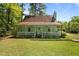 Charming home with a covered front porch, manicured lawn, and lush greenery at 209 Pen Lou Ct, Angier, NC 27501