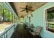 Spacious porch featuring ceiling fans, comfortable chairs, and natural light at 209 Pen Lou Ct, Angier, NC 27501