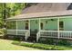 Inviting covered porch featuring comfortable seating and stylish ceiling fans at 209 Pen Lou Ct, Angier, NC 27501