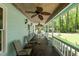 Cozy covered porch with a ceiling fan, chairs, and a view of the yard at 209 Pen Lou Ct, Angier, NC 27501
