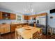 Bright kitchen with stainless steel appliances, wood cabinets, and a dining table with wooden chairs at 209 Pen Lou Ct, Angier, NC 27501