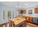 Eat-in kitchen with wood floors, ample natural light, and white appliances, perfect for Gathering meals at 209 Pen Lou Ct, Angier, NC 27501