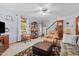 Bright living room with a display cabinet, windows, and a grandfather clock, creating a welcoming space at 209 Pen Lou Ct, Angier, NC 27501