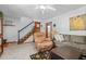 Spacious living room with plush seating, stairs, and a grandfather clock, perfect for Gathering gatherings at 209 Pen Lou Ct, Angier, NC 27501