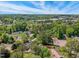 Aerial view showcasing the neighborhood, with mature trees and beautiful blue skies at 2211 Hillock Dr, Raleigh, NC 27612