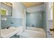 Bathroom featuring blue tiling and a shower and bathtub combo at 2211 Hillock Dr, Raleigh, NC 27612