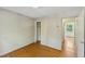 Vacant bedroom featuring a closet with open door and hardwood flooring at 2211 Hillock Dr, Raleigh, NC 27612