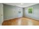 Bedroom featuring hardwood floors and two windows for natural light at 2211 Hillock Dr, Raleigh, NC 27612