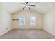 Bedroom with vaulted ceilings, carpeted floors, neutral walls, and two windows for natural light at 2211 Hillock Dr, Raleigh, NC 27612