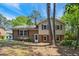 Charming two-story home featuring brick and siding with red shutters, surrounded by mature trees and landscaping at 2211 Hillock Dr, Raleigh, NC 27612